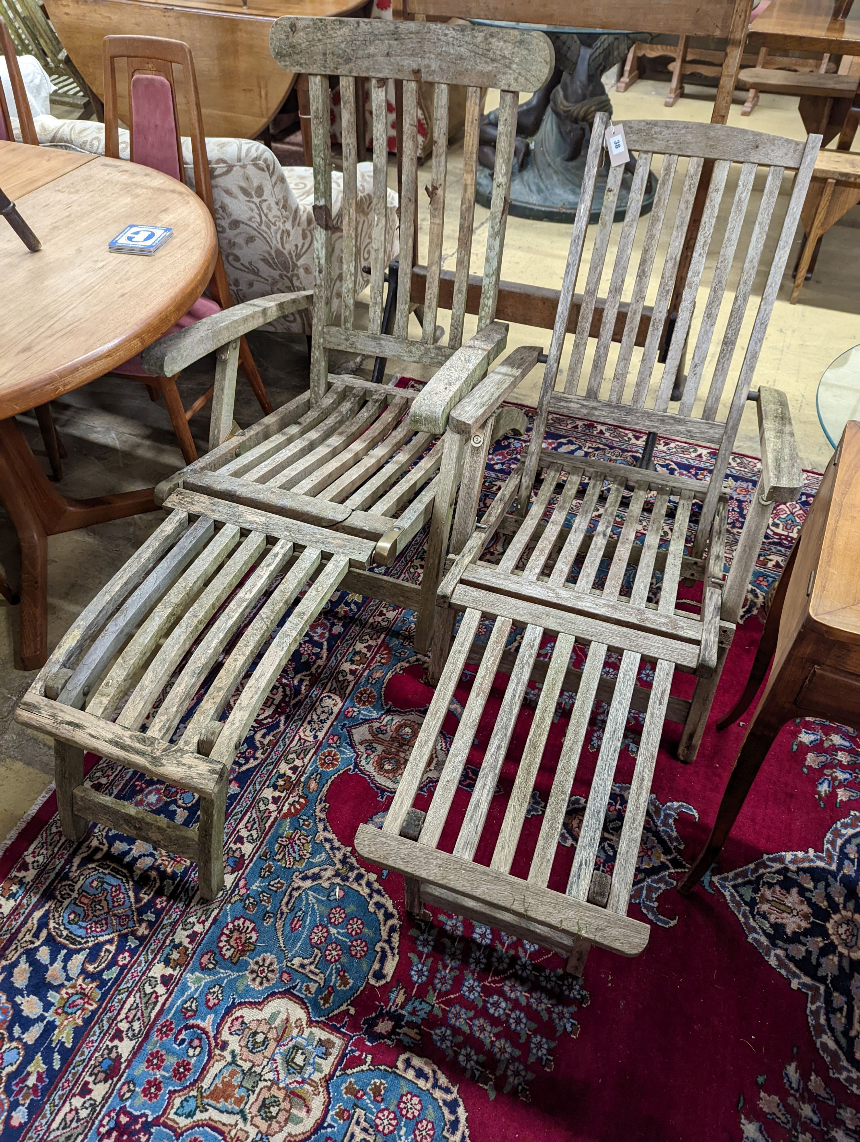 Two weathered teak garden steamer chairs. Heights for both chairs, 102cm and 88cm.